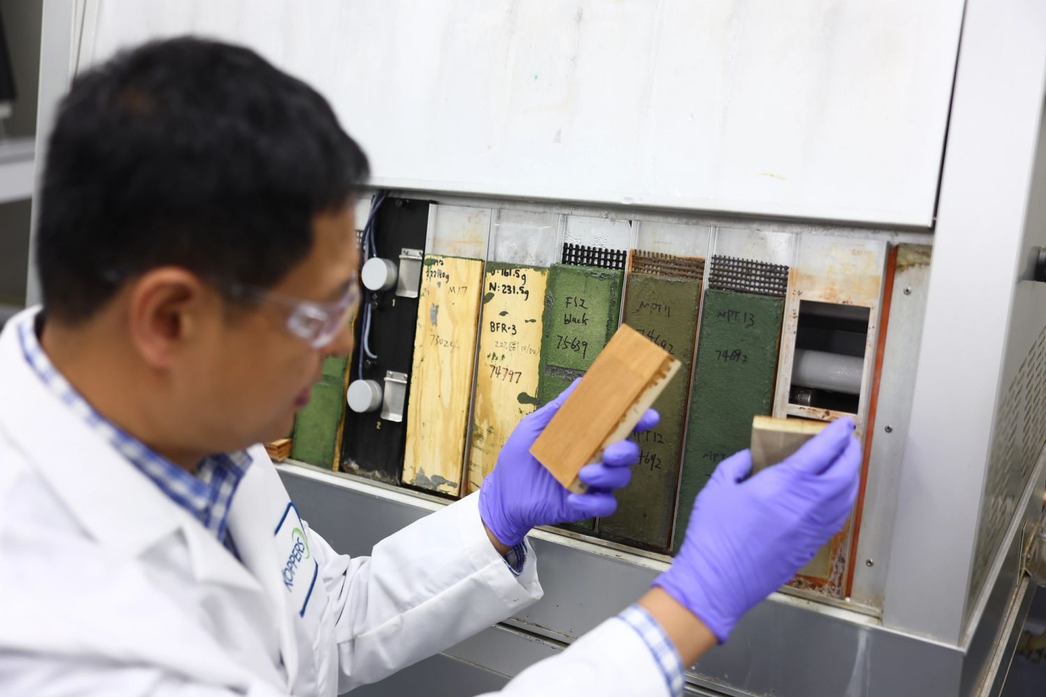 A Koppers Performance Chemicals technical specialist supporting a customer in the laboratory