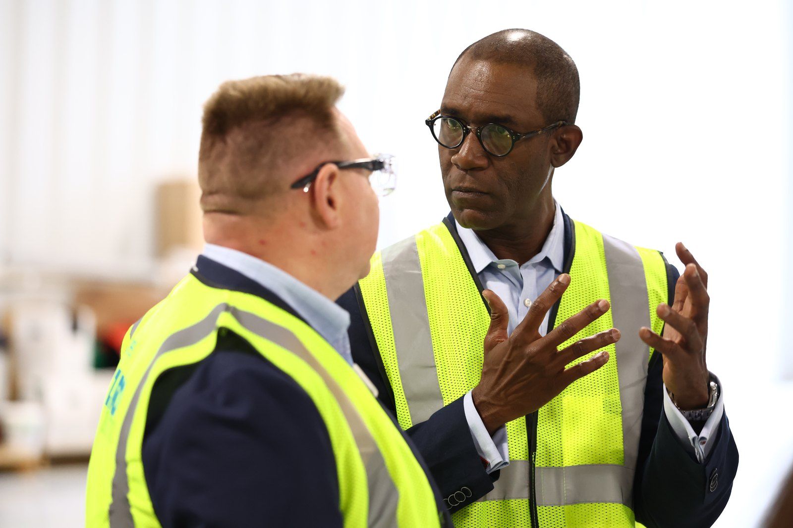 Two colleagues in hi-vis talking through a job on site