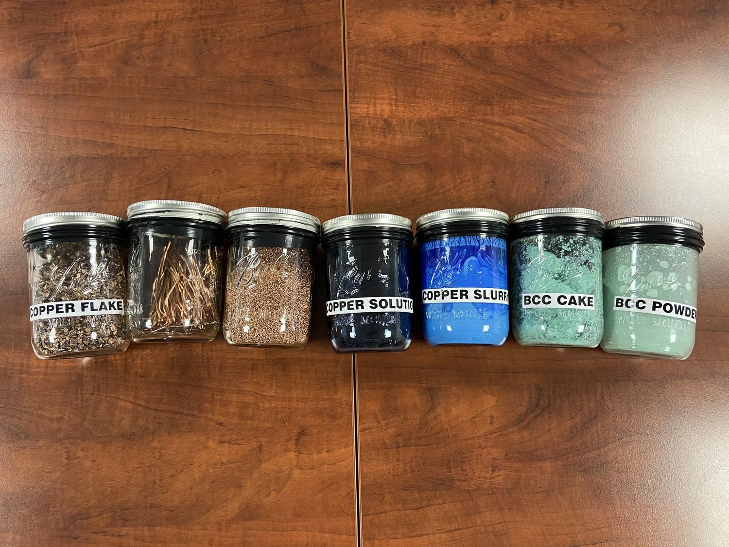 Labelled jars showing each stage of copper preservative production