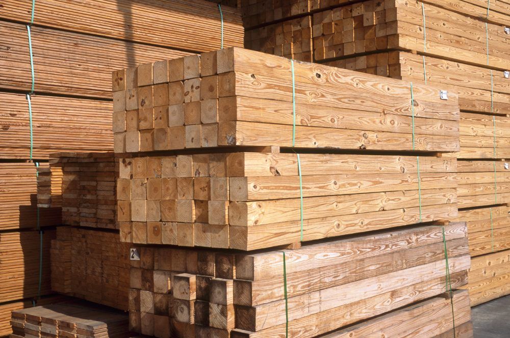 Treated lumber stacked at a production facility
