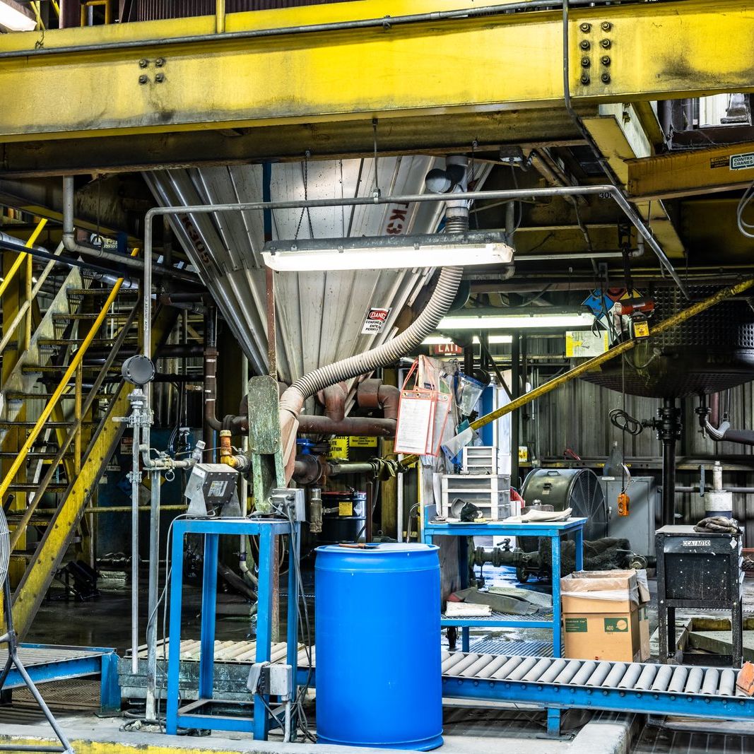 Operator moving material through a preservative plant