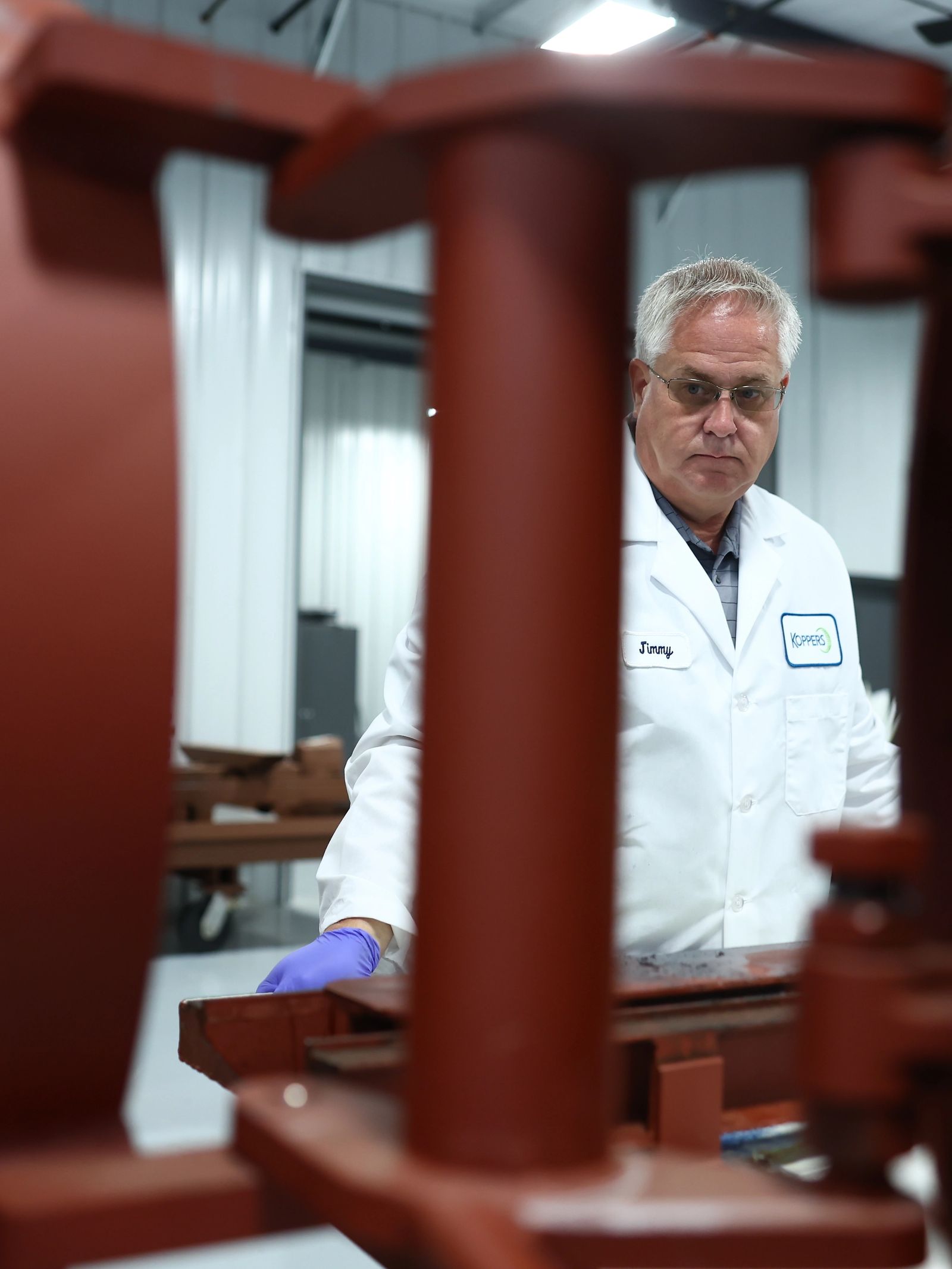Koppers scientist in hi-vis and safety glasses on the plant floor