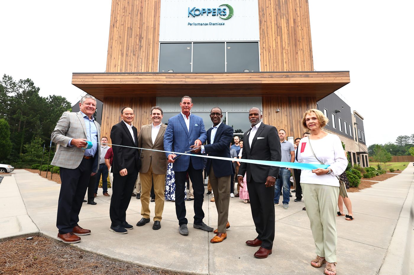 Ribbon-cutting outside the Koppers Performance Chemicals building