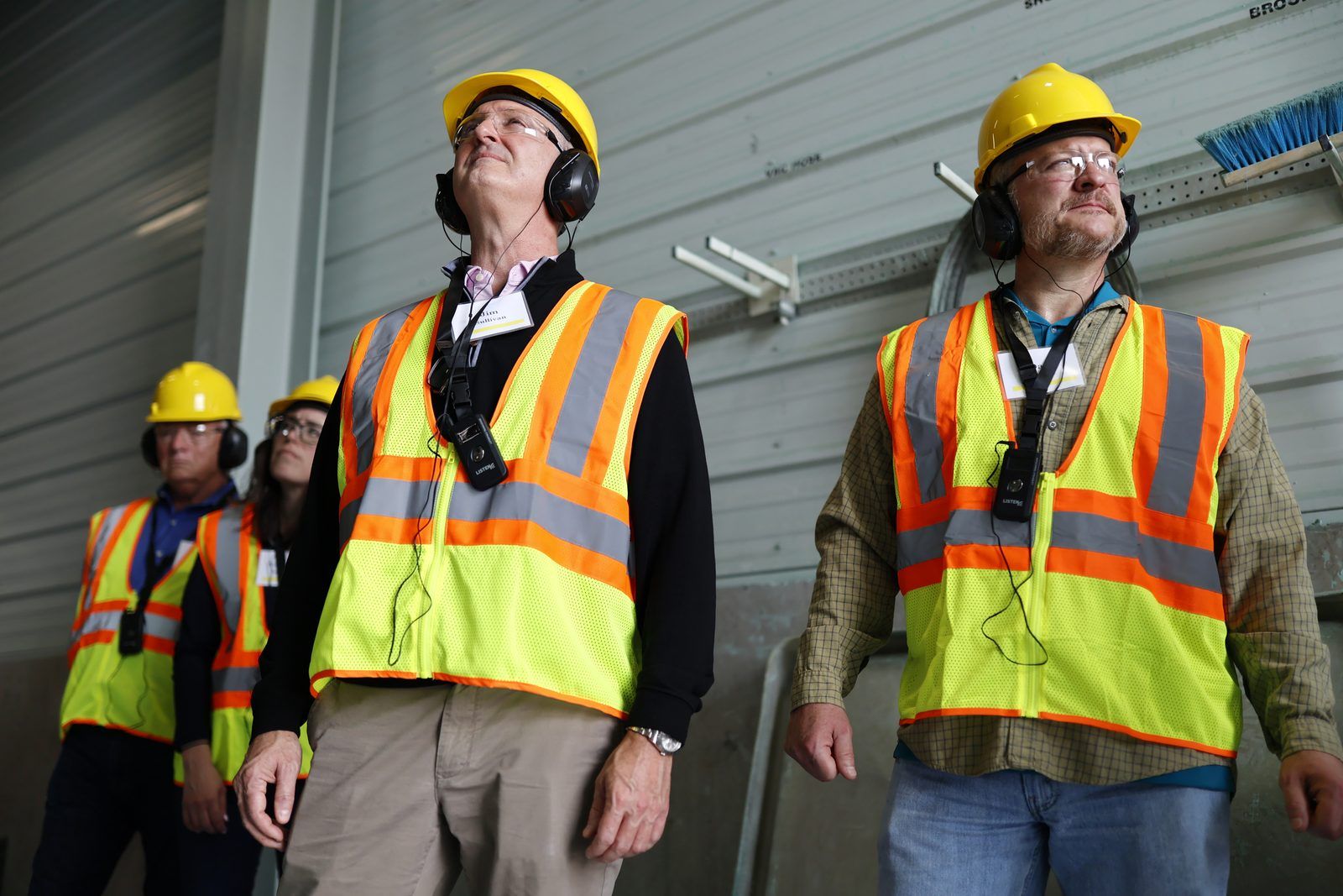 Plant staff in high-visibility gear on the production floor