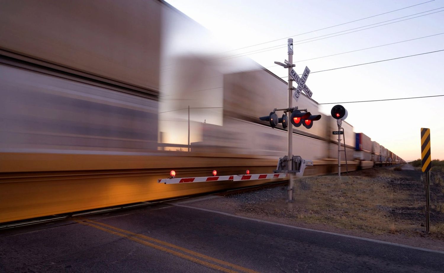 Freight train passing a rural crossing