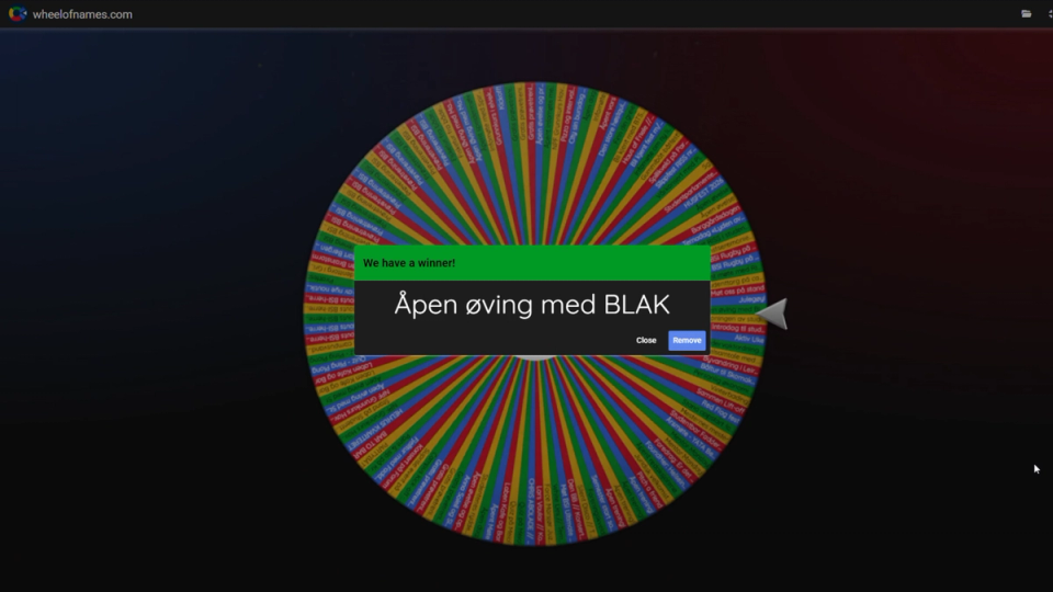 A colorful Wheel of Names fills the screen, overlaid by a winner announcement reading “Åpen øving med BLAK.”