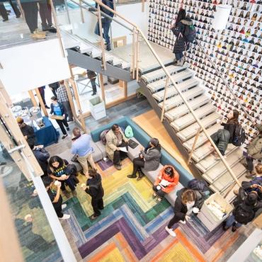 stairs, wall of photos, and students marveling at it all
