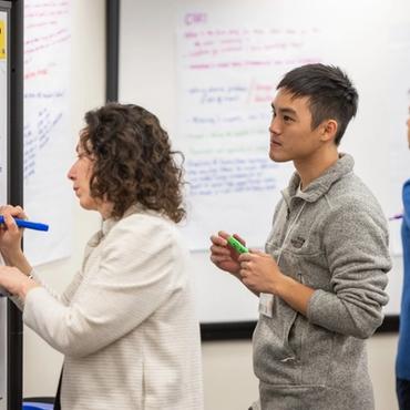 A woman chats with a group of people