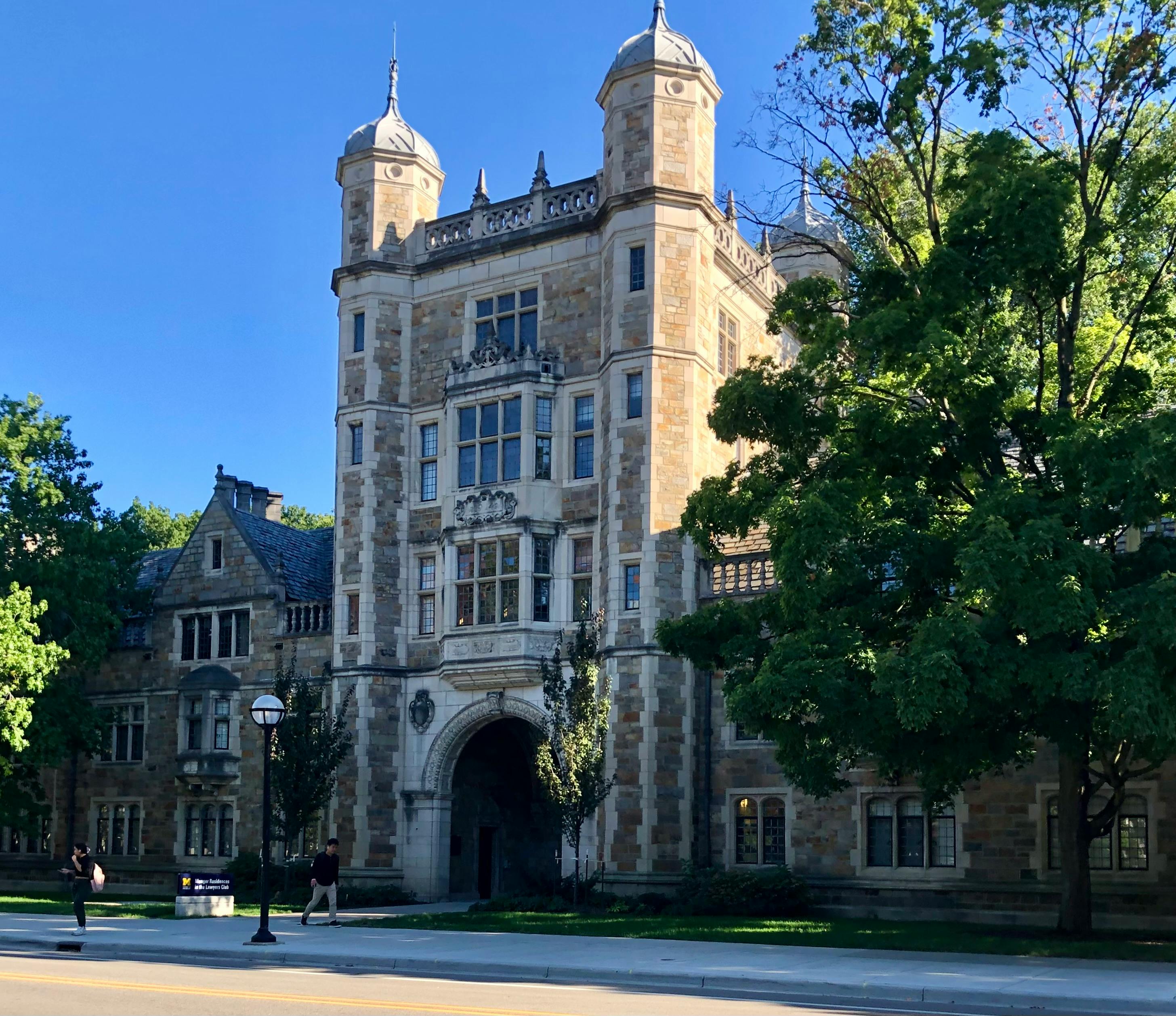University of Michigan Law Quad entrance, framed by late-summer greenery.