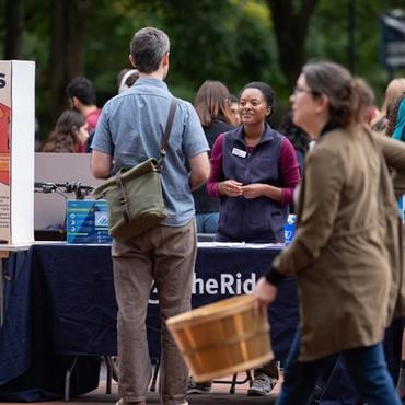 A representative from The Ride chats with a man