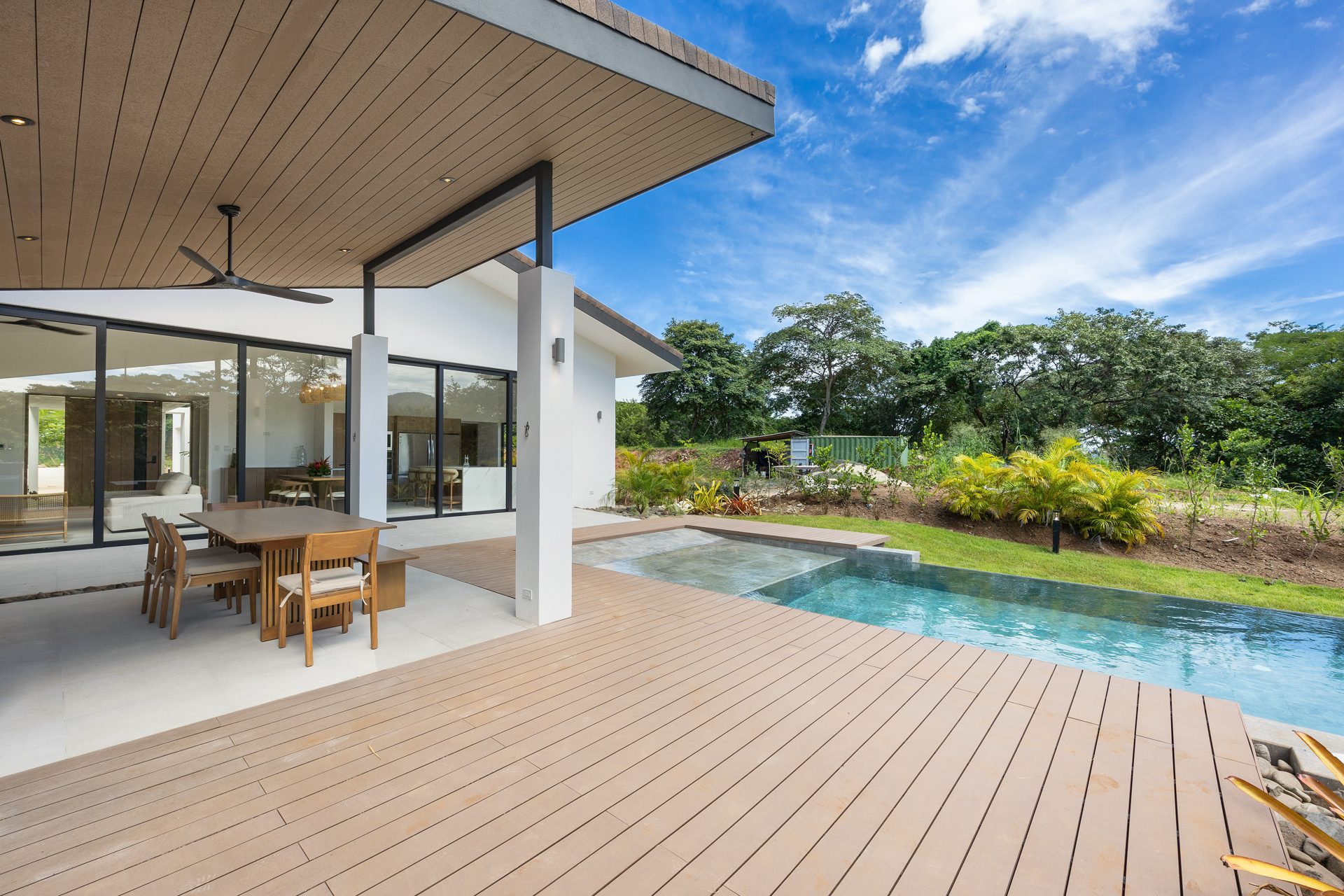Pool deck and covered terrace with golf course greenery – Casa Aguasalada, Reserva Conchal, Guanacaste, Costa Rica