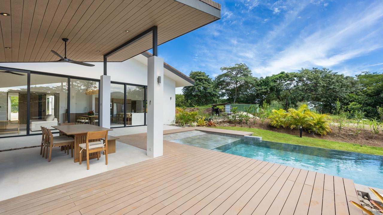 Pool deck and covered terrace with golf course greenery – Casa Aguasalada, Reserva Conchal, Guanacaste, Costa Rica