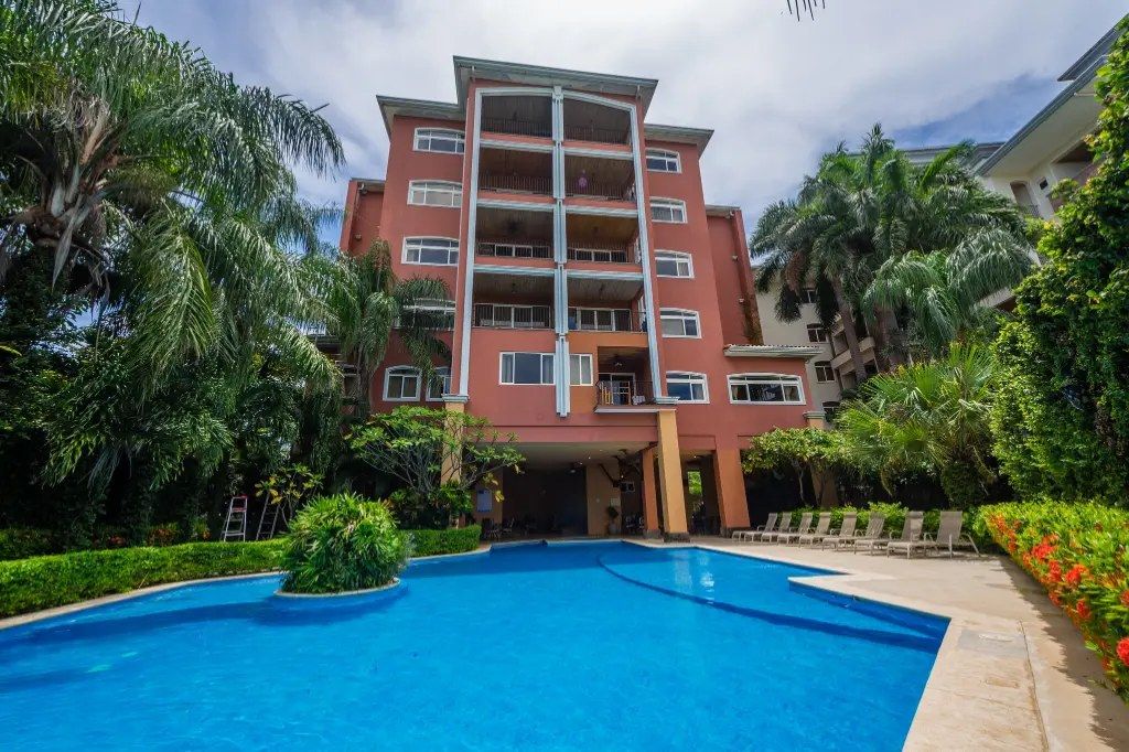 Naxos condo building with pool and tropical gardens – Naxos #8, Playa Langosta, Tamarindo, Guanacaste, Costa Rica