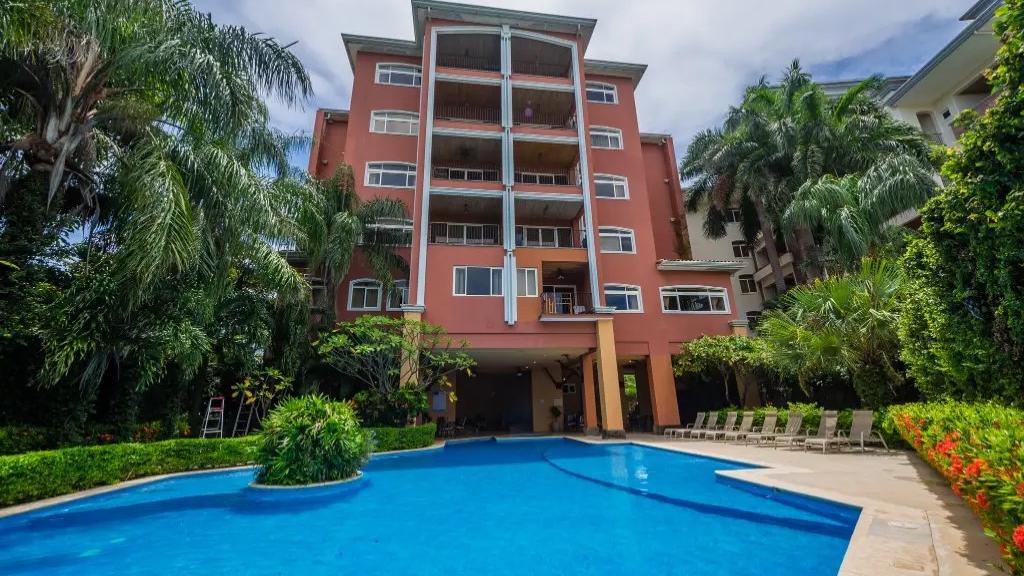 Naxos condo building with pool and tropical gardens – Naxos #8, Playa Langosta, Tamarindo, Guanacaste, Costa Rica