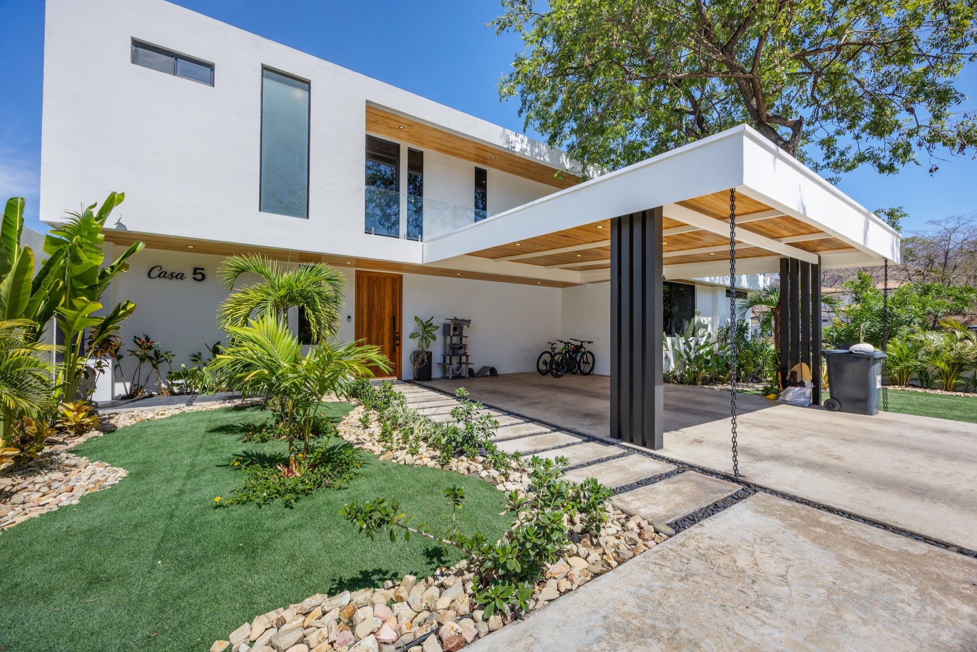 Front facade with glass walls and landscaping – Casa Bohemia Ceibo 5, Reserva Conchal, Guanacaste, Costa Rica