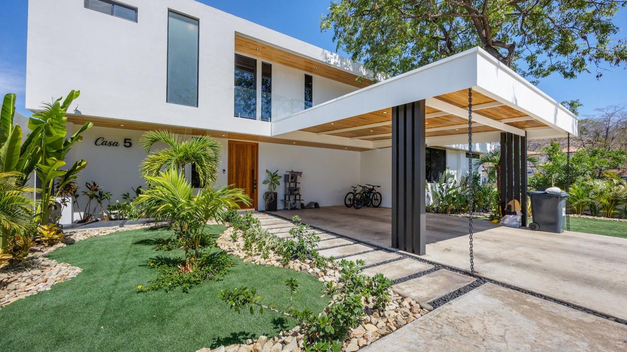 Front facade with glass walls and landscaping – Casa Bohemia Ceibo 5, Reserva Conchal, Guanacaste, Costa Rica