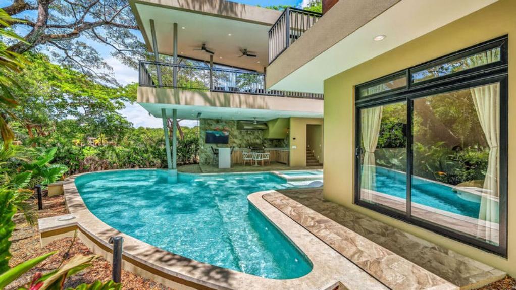 Curved pool and garden beside the home – Llama del Bosque #22, Casa 22, Reserva Conchal, Guanacaste, Costa Rica
