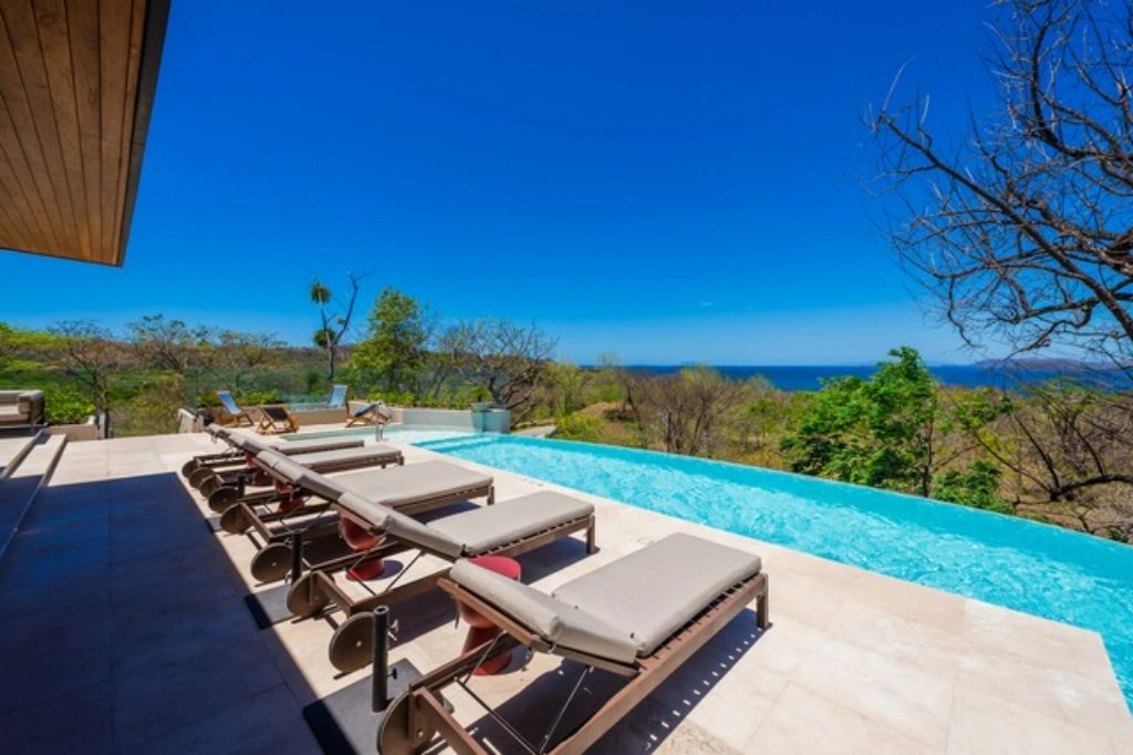 Infinity pool deck with loungers and ocean view – W6 Residence | W Costa Rica, Reserva Conchal, Guanacaste, Costa Rica