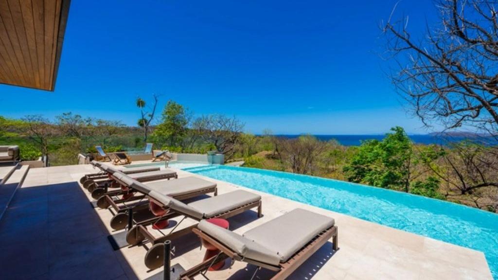 Infinity pool deck with loungers and ocean view – W6 Residence | W Costa Rica, Reserva Conchal, Guanacaste, Costa Rica