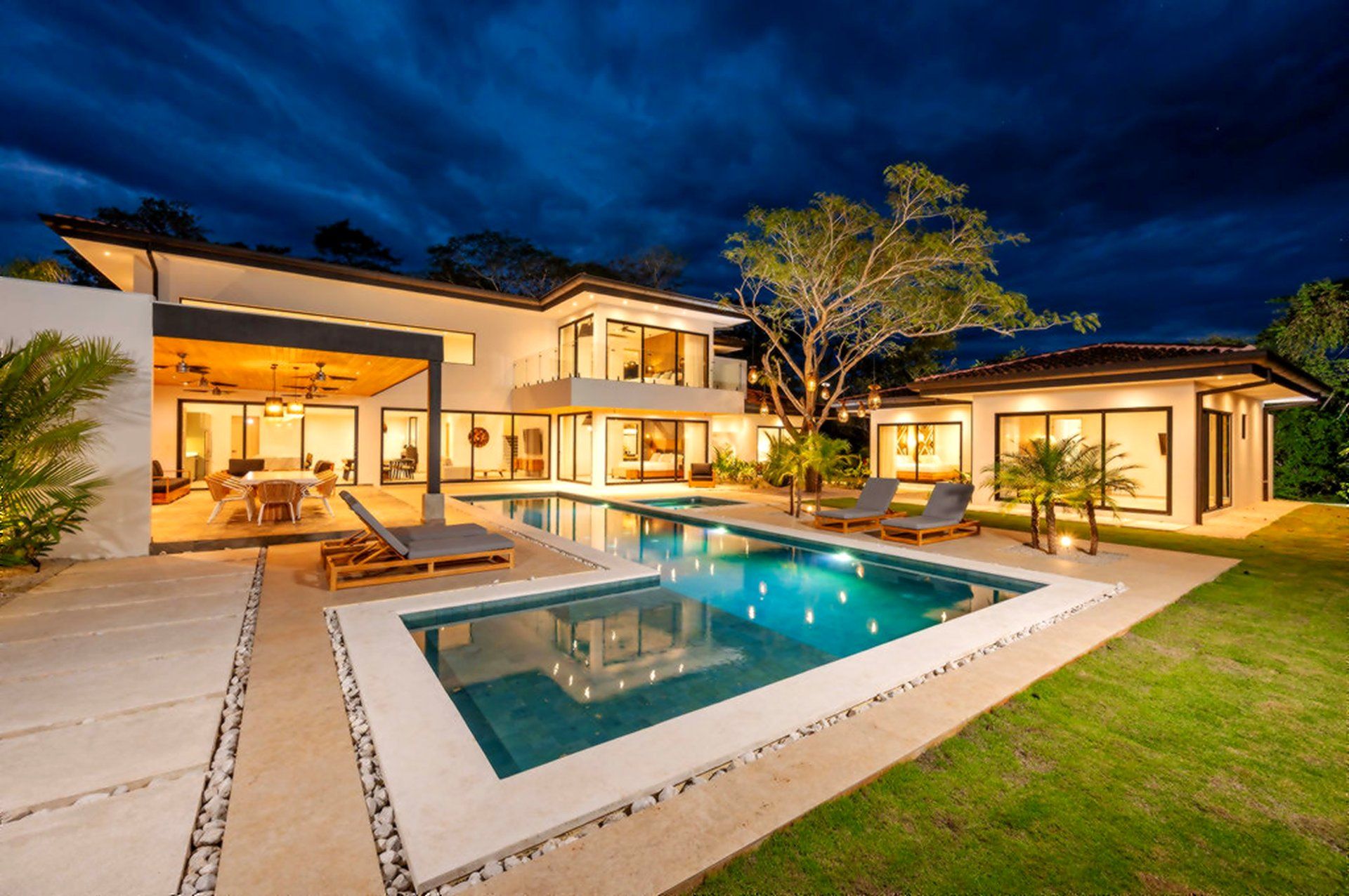 Casa Bettina at dusk with illuminated pool and covered terrace