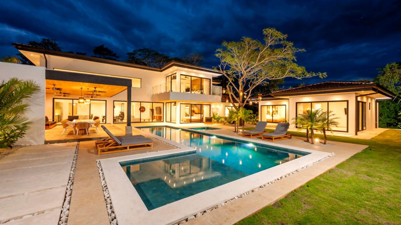 Casa Bettina at dusk with illuminated pool and covered terrace