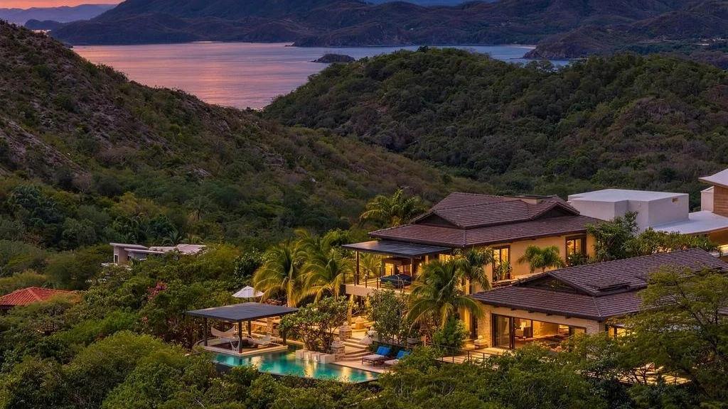 Aerial view of the villa and pool at dusk over the bay – Casa Shiva, Mar Vista, Playa Flamingo, Guanacaste, Costa Rica