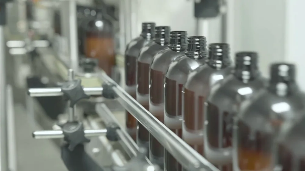 Filled liquid supplement bottles coming off the line at a nutraceutical contract manufacturer