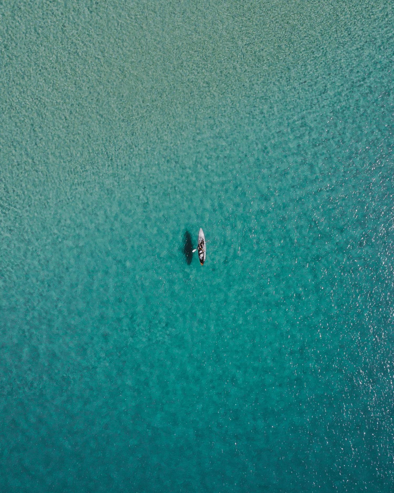 ocean shot of single kayak