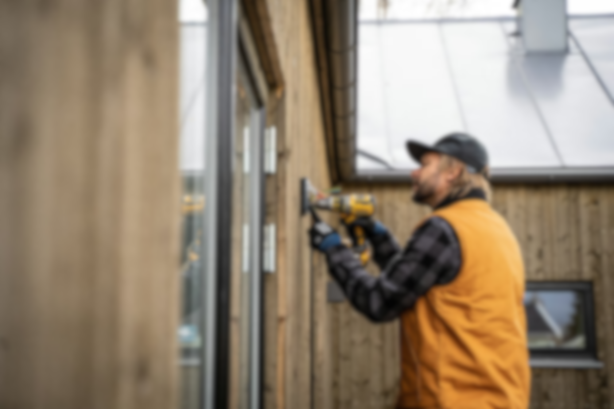 Electrician in background installing an outlet