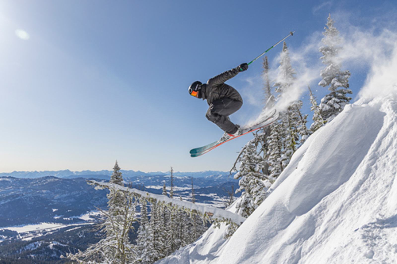 Skier jumping off a cliff