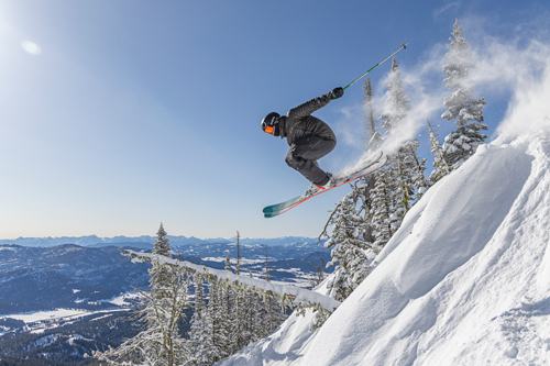 Skier jumping off a cliff