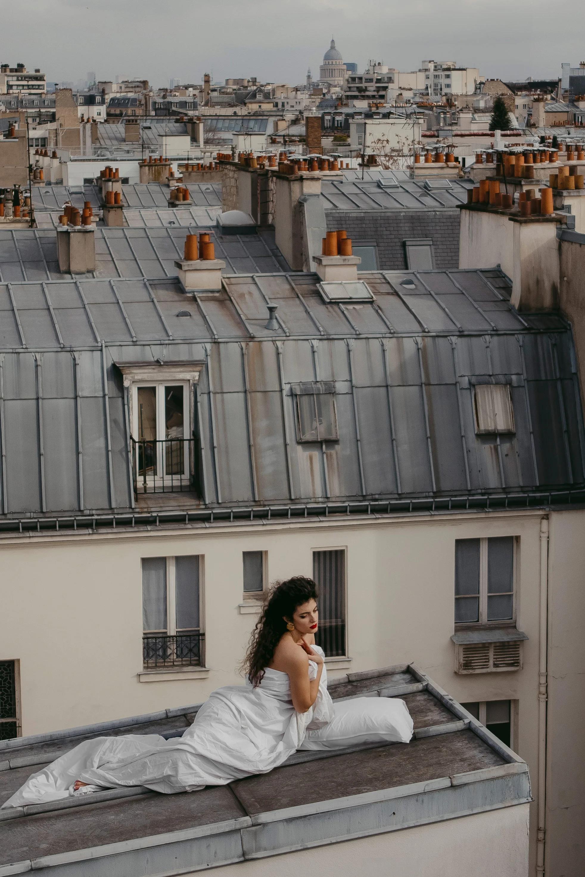 Virna on the rooftops in a white dress