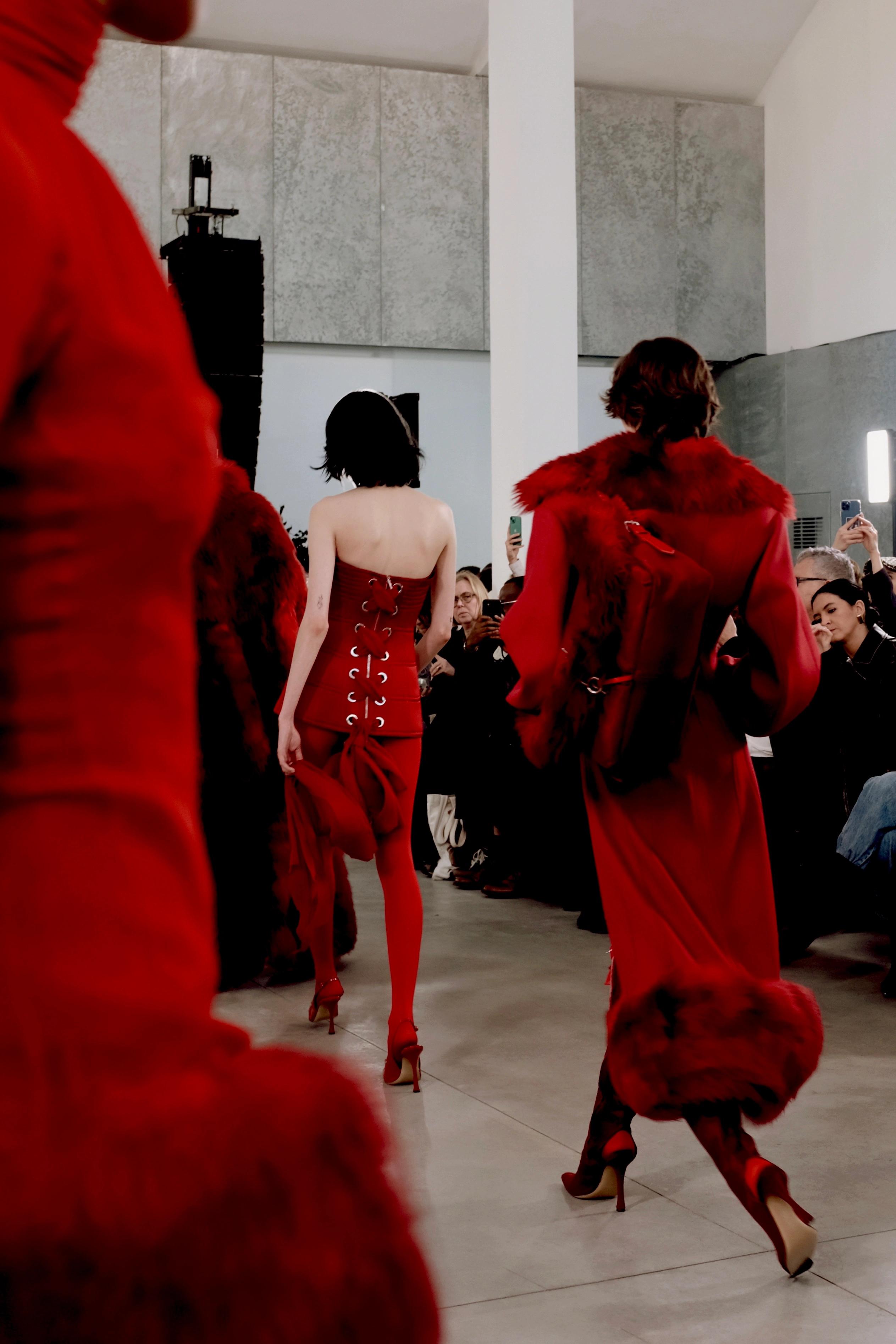 fashion show with models dressed in red