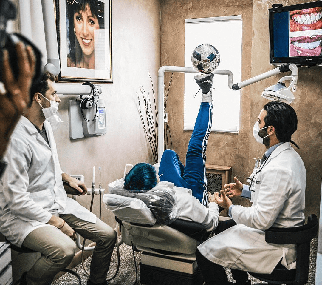 Two dentists treating a patient in a Bensonhurst Dental treatment room