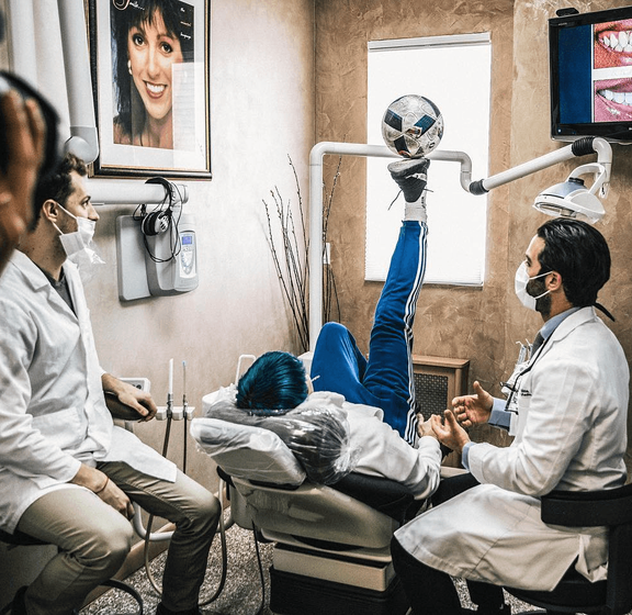 Two dentists treating a patient in a Bensonhurst Dental treatment room