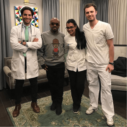 Music producer Jermaine Dupri posing with the dental team in the clinic's waiting area
