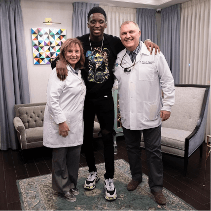 Basketball player Victor Oladipo posing with the team at Bensonhurst Dental Care