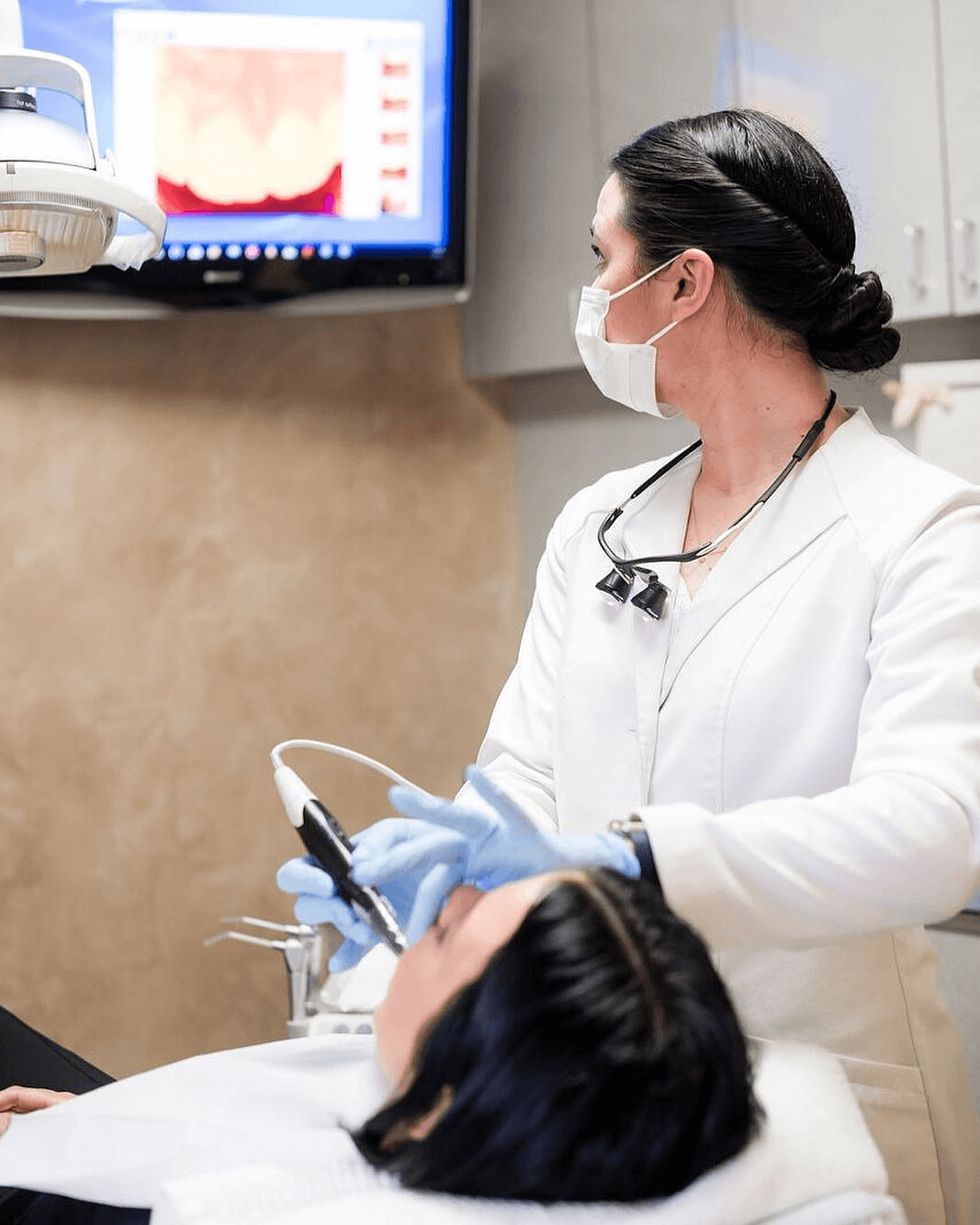 Dentist examining a patient with an intraoral camera