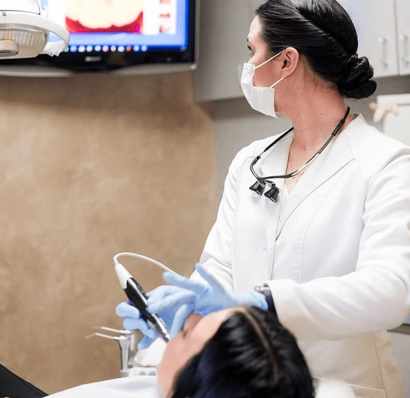 Dentist examining a patient with an intraoral camera