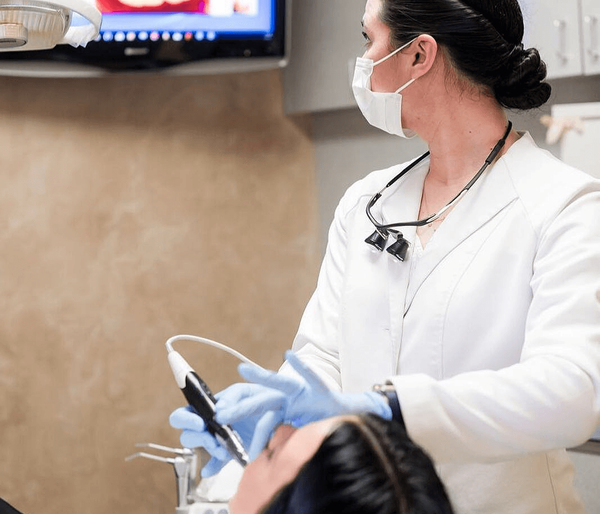 Dentist examining a patient with an intraoral camera