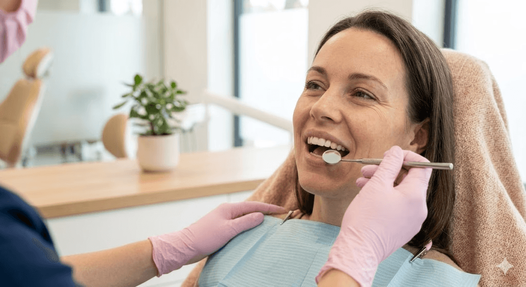 Dentist examining a patient's teeth with a mirror