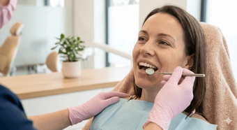 Dentist examining a patient's teeth with a mirror
