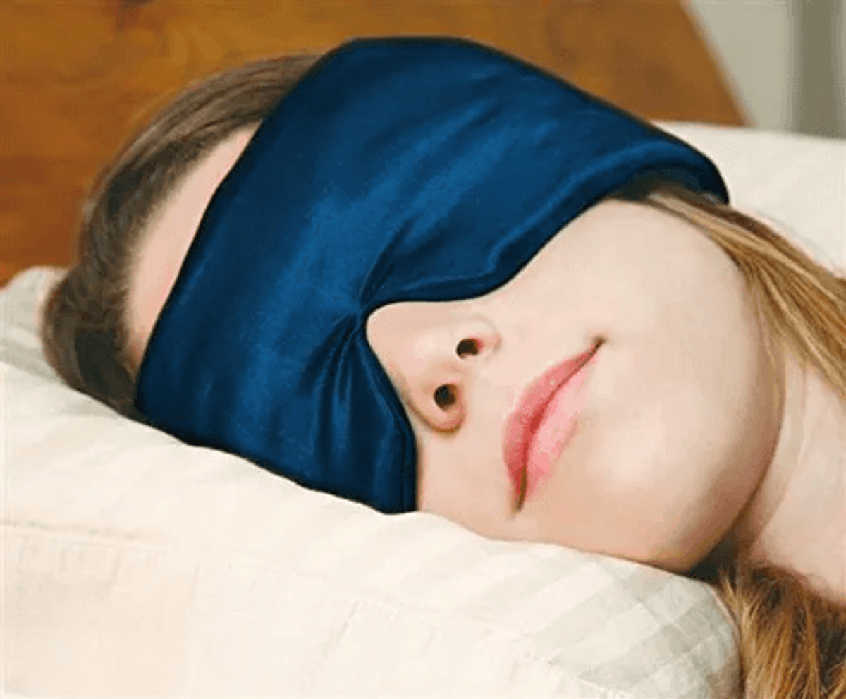 Woman sleeping with a silk sleep mask