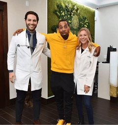 Television personality JoJo Simmons posing with the team at Bensonhurst Dental Care