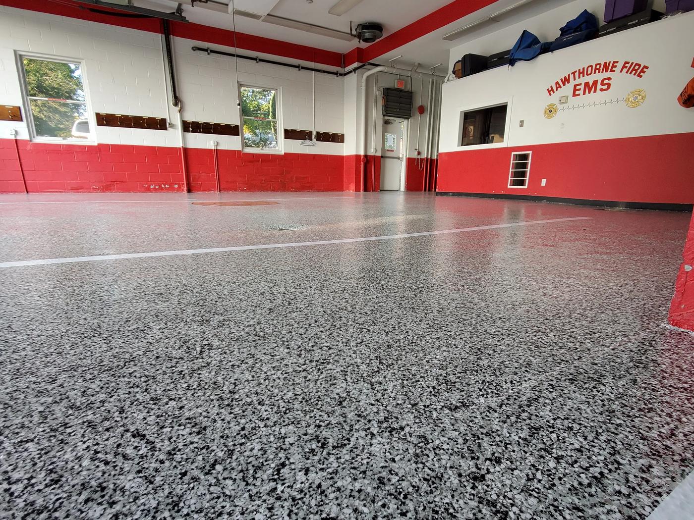 Commercial firehouse floor coating project in progress.