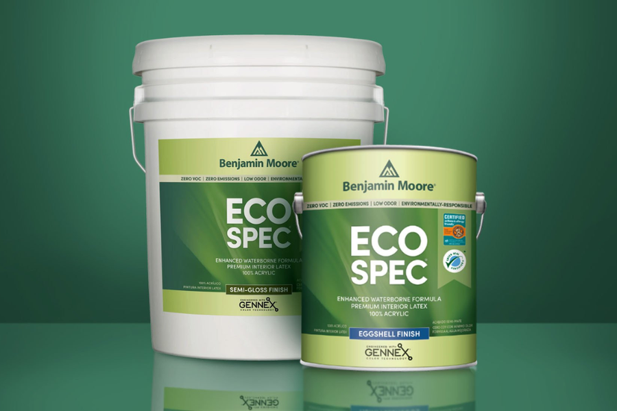 A five-gallon bucket and one-gallon can of Benjamin Moore Eco Spec paint, labeled zero VOC and zero emissions, on a dark green background.