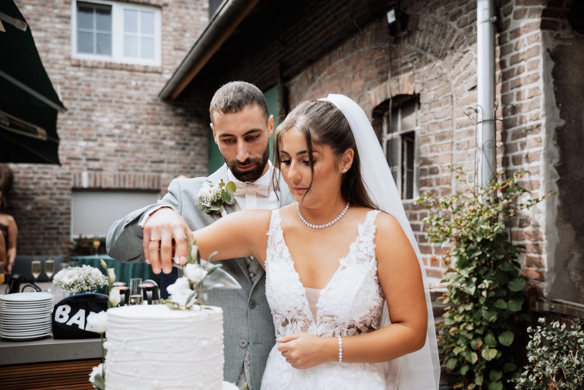 Merve und Timur schneiden gemeinsam die Torte an