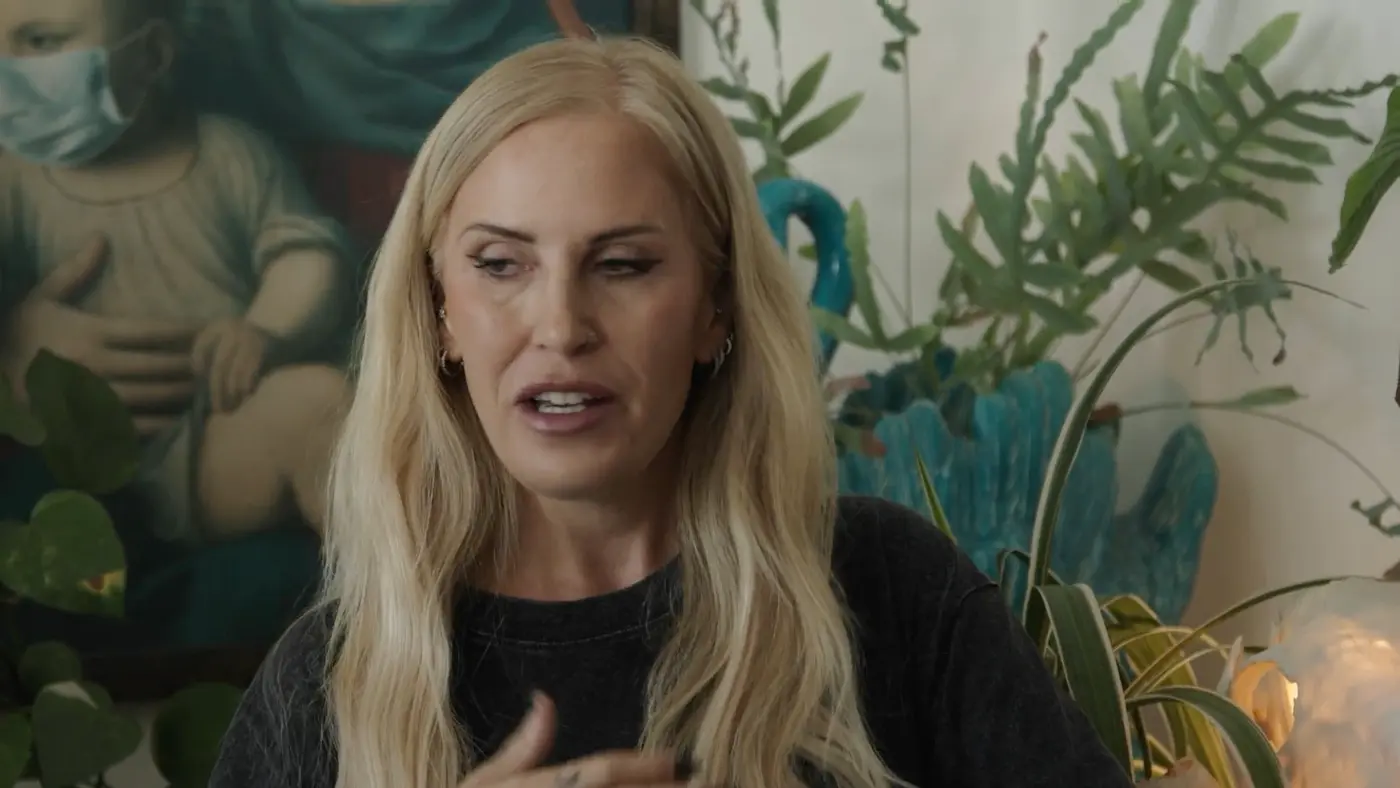 Nina, the Leigh Witch, talking to camera in her living room