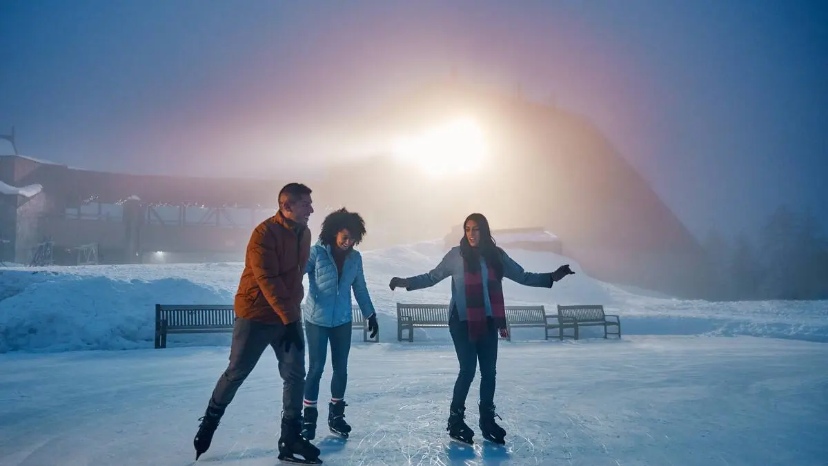 Three people ice skating at Grouse Mountain near Vancouver