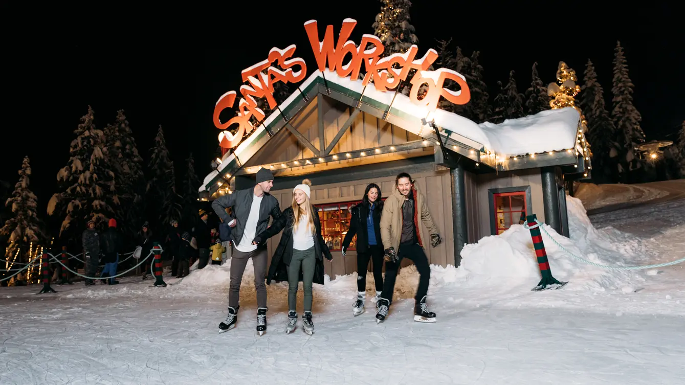 A group of ice skaters on a frozen pond at Grouse Mountain near Vancouver